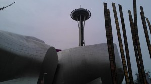 The Space Needle looming over the EMP museum.  EMP is short for Evoking Money from Patrons.